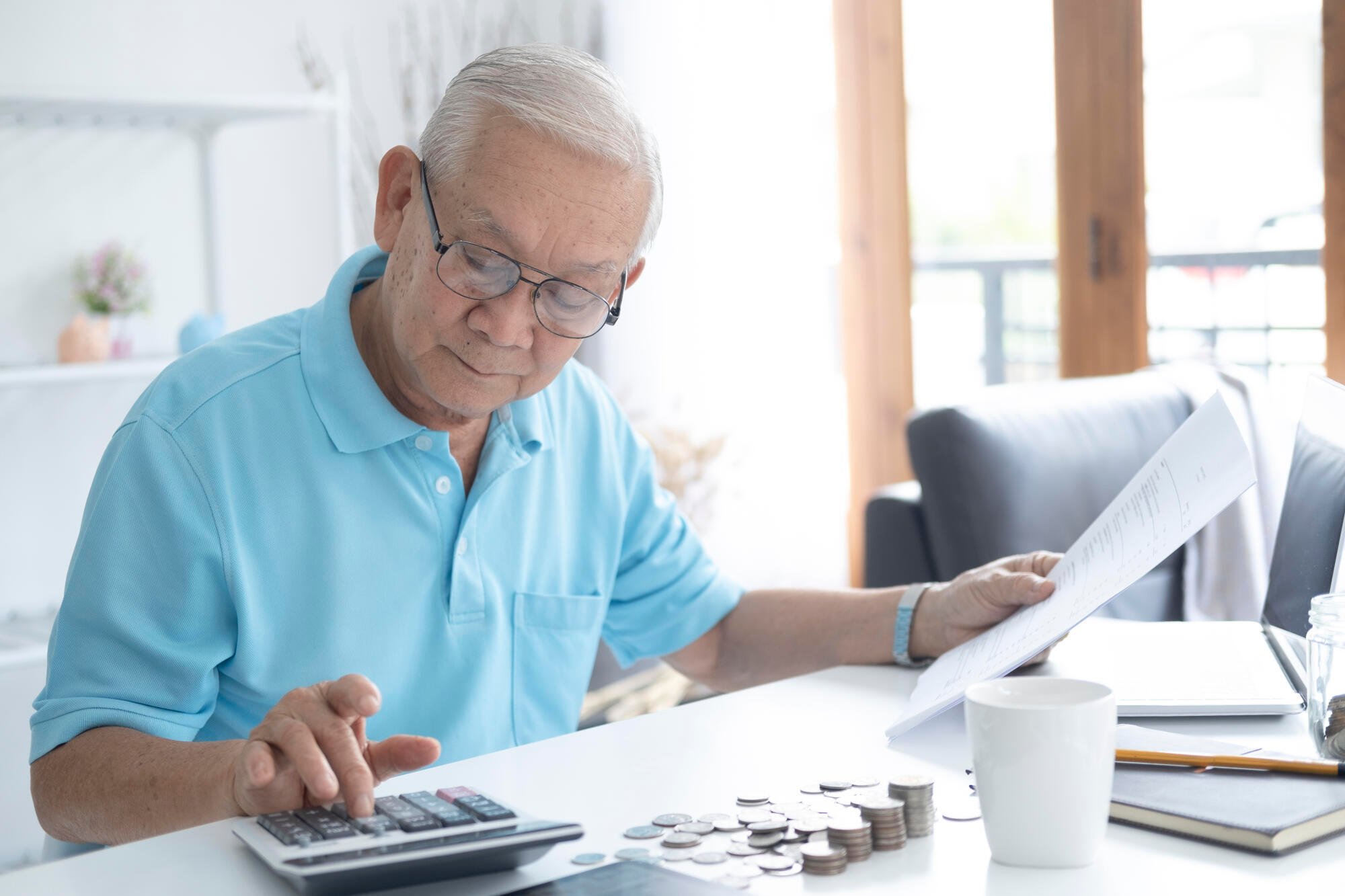 Senior-man-calculating-taxes-a